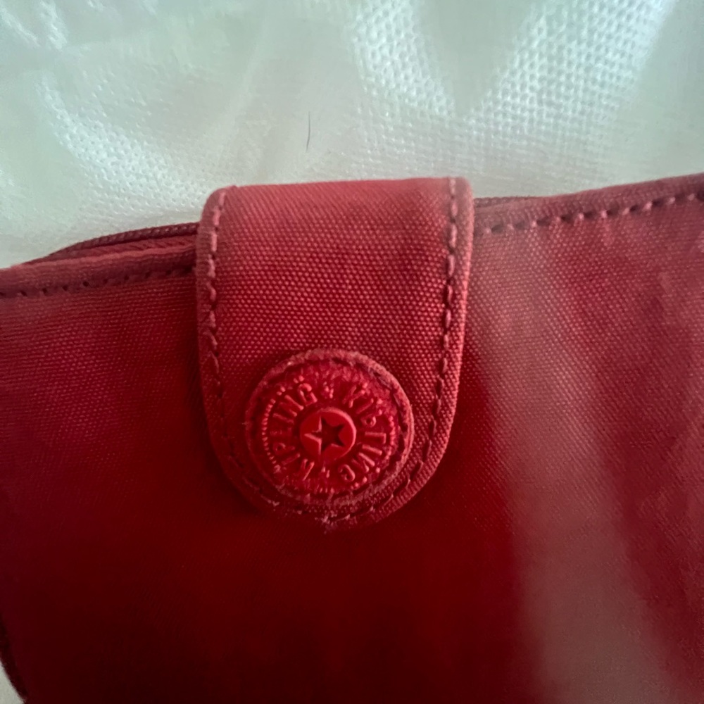 Kipling Red Cosmetic Bag with Embossed Logo and Seamless Stitching